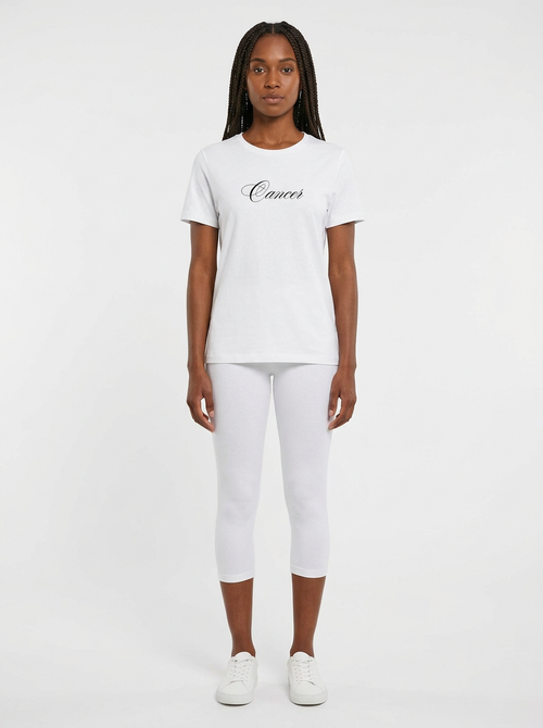 Model in the Cancer White Top with white capris