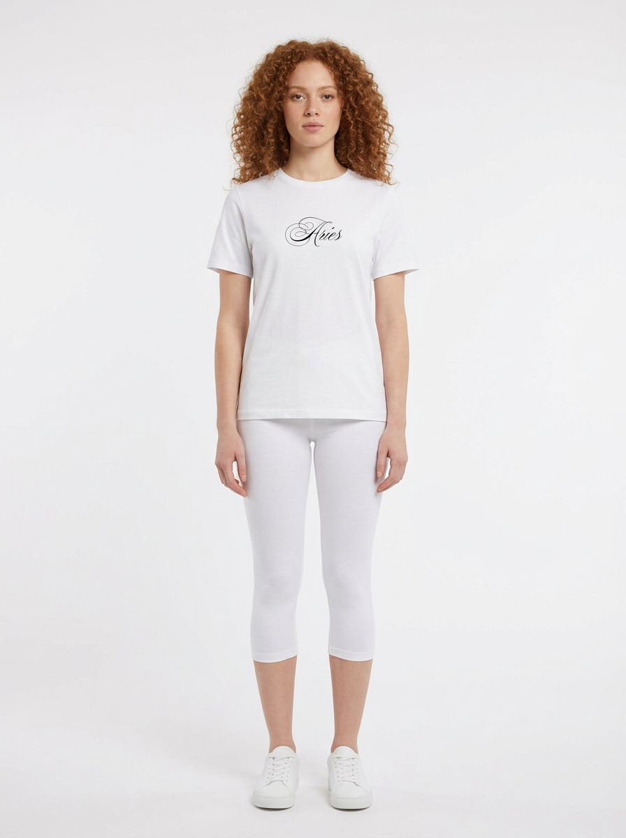 Model in the Aries White Top with white capris
