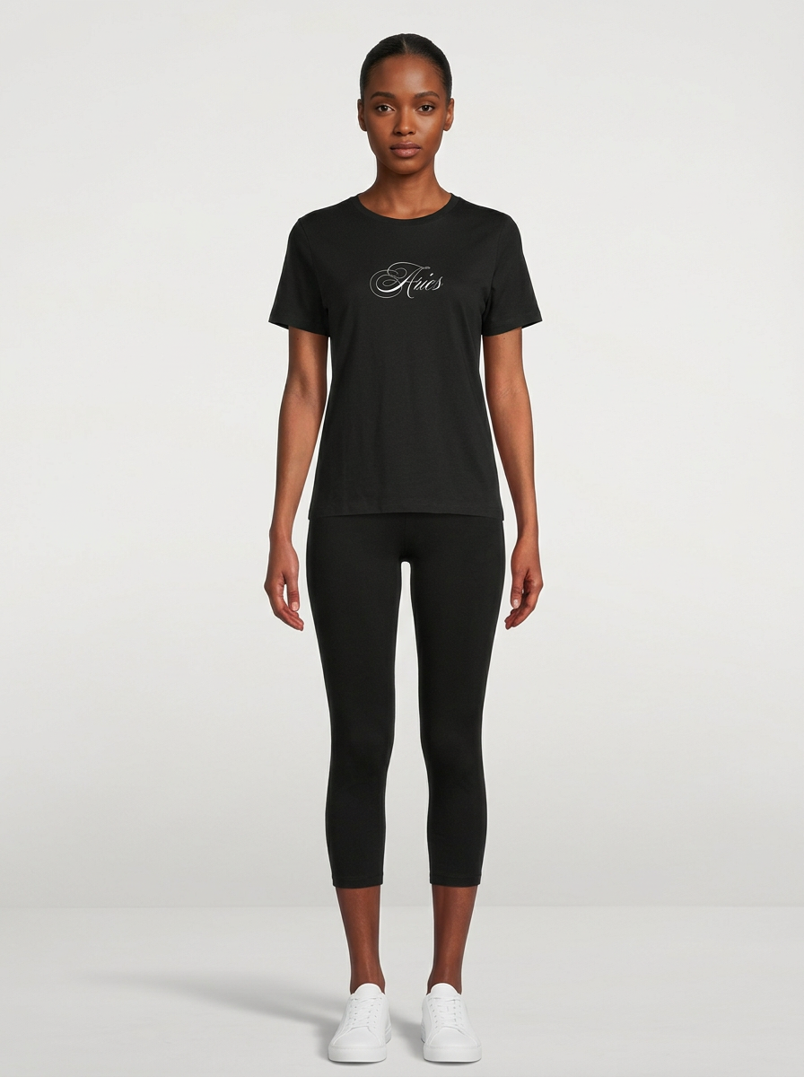 Model in the Aries Black Top with black capris
