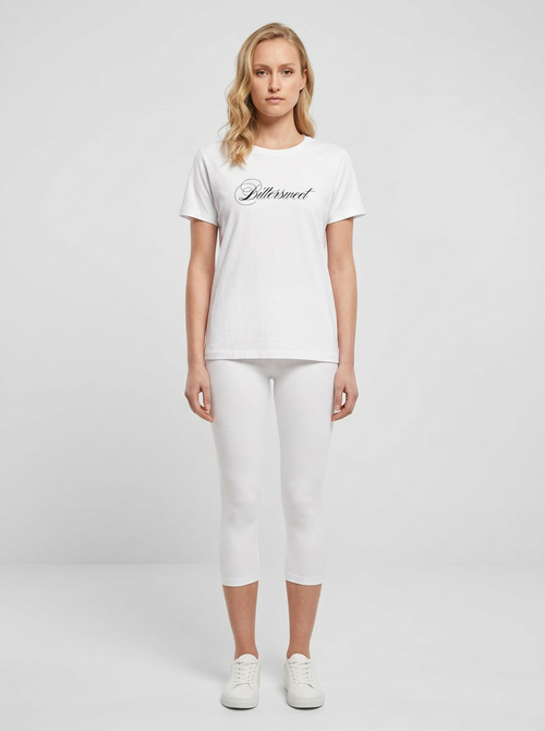 Model in the Bittersweet White Top with white capris